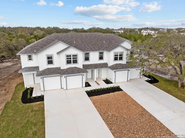 an aerial view of residential houses with outdoor space