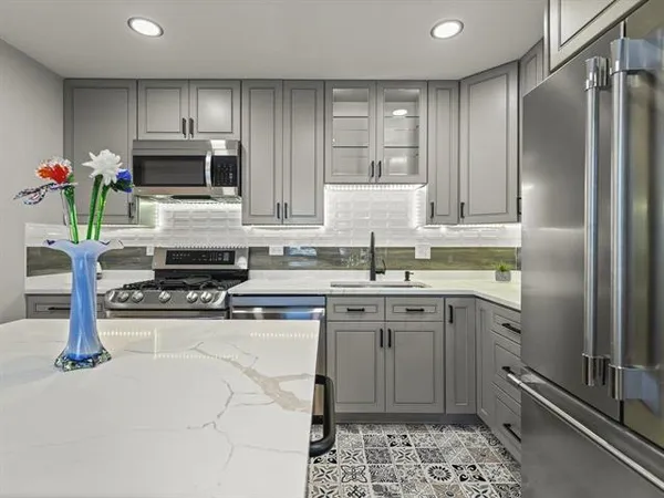 a kitchen that has a sink and a stove in it
