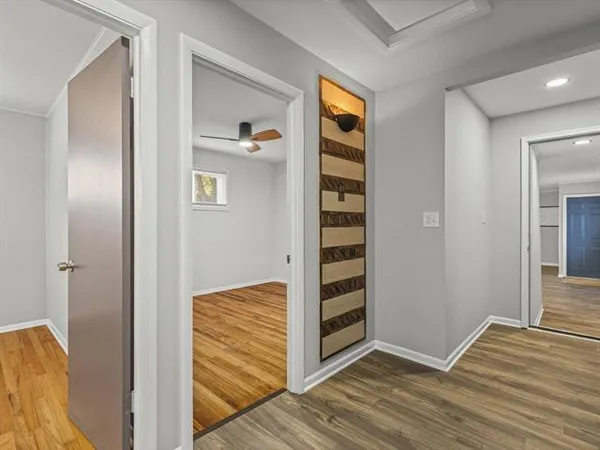 a view of empty room with wooden floor