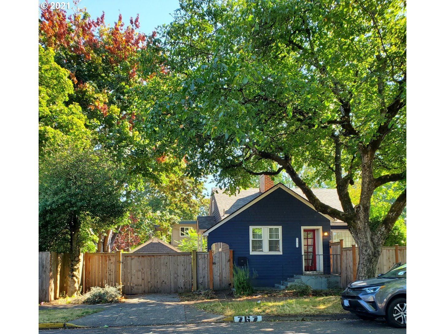 a front view of a house with a garden