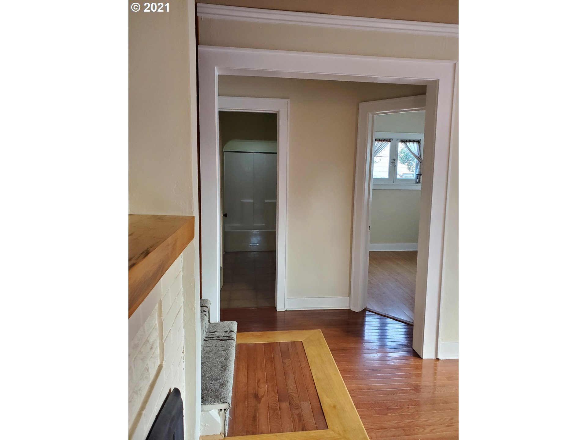 767 Madison Street Eugene, OR 97402 - Photo 6 of 20 a view of a hallway with wooden floor and staircase