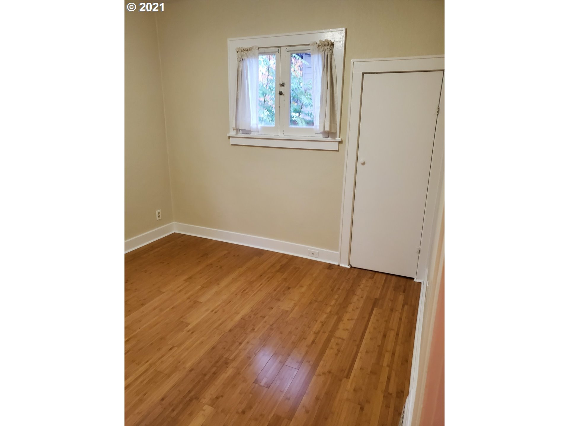 767 Madison Street Eugene, OR 97402 - Photo 10 of 20 a view of an empty room with wooden floor