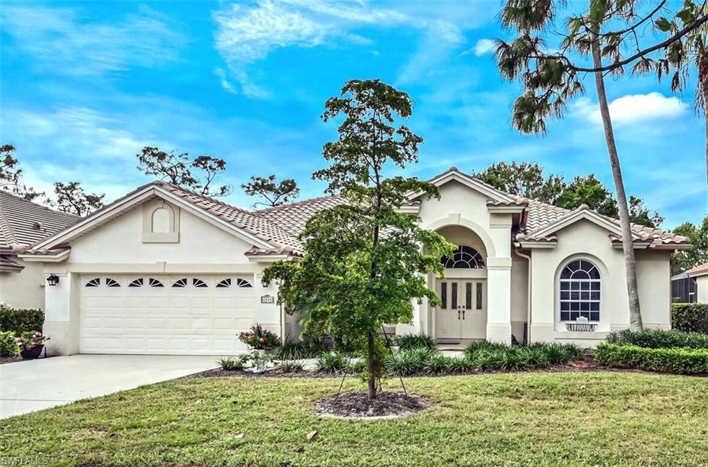 6545 Chestnut Circle Naples, FL 34109 - Photo 1 of 43 a view of a white house with a small yard and large tree