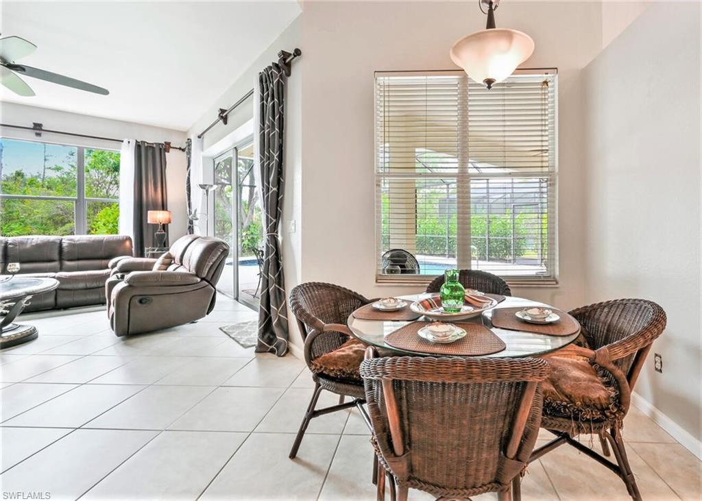 6545 Chestnut Circle Naples, FL 34109 - Photo 14 of 43 a living room with furniture and a large window
