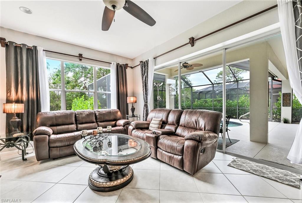 6545 Chestnut Circle Naples, FL 34109 - Photo 16 of 43 a living room with furniture and a large window