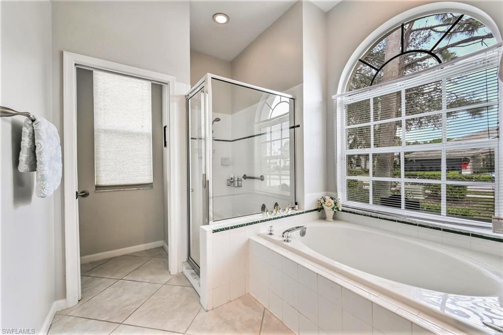 6545 Chestnut Circle Naples, FL 34109 - Photo 21 of 43 a bathroom with a tub and a shower