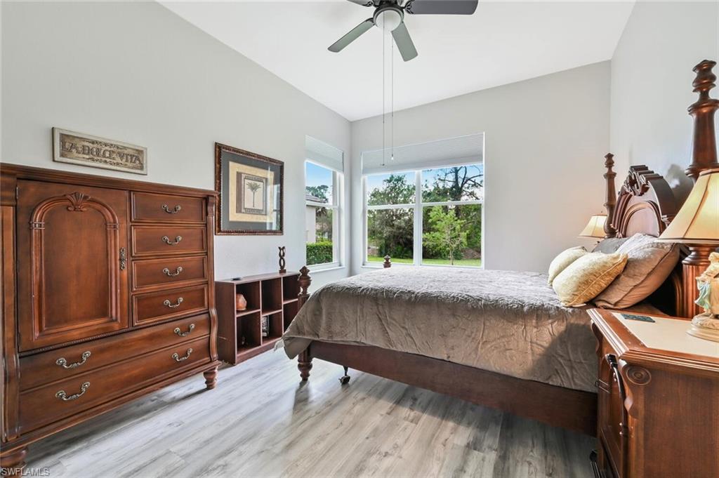 6545 Chestnut Circle Naples, FL 34109 - Photo 23 of 43 a bed sitting in a bedroom next to a window