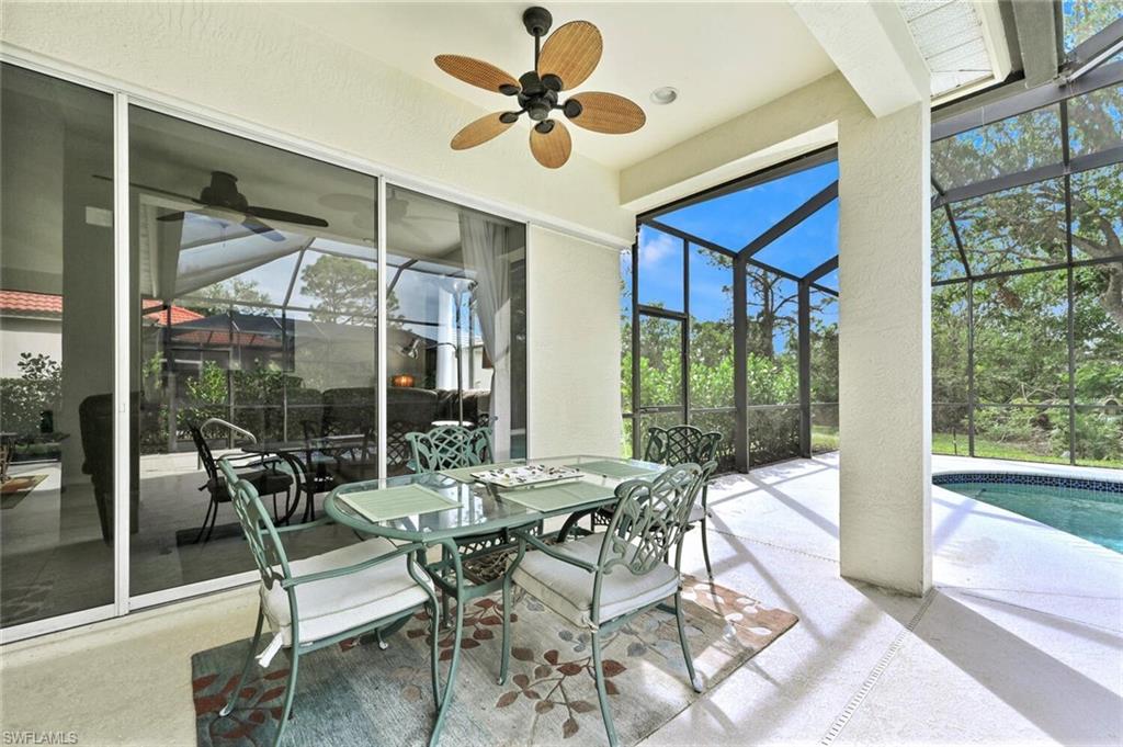 6545 Chestnut Circle Naples, FL 34109 - Photo 32 of 43 a view of a dining room with furniture wooden floor and a chandelier