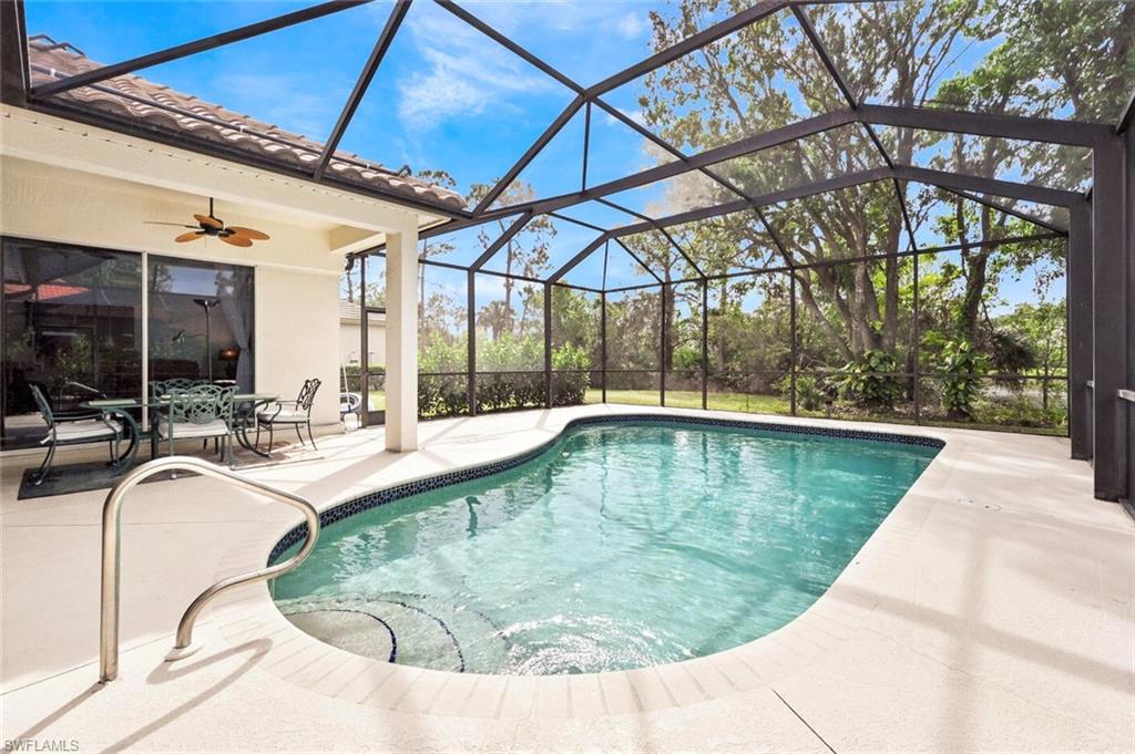 6545 Chestnut Circle Naples, FL 34109 - Photo 33 of 43 a view of a swimming pool with a patio