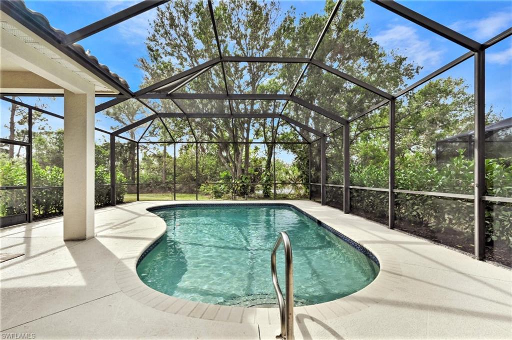 6545 Chestnut Circle Naples, FL 34109 - Photo 34 of 43 a view of a swimming pool with a patio