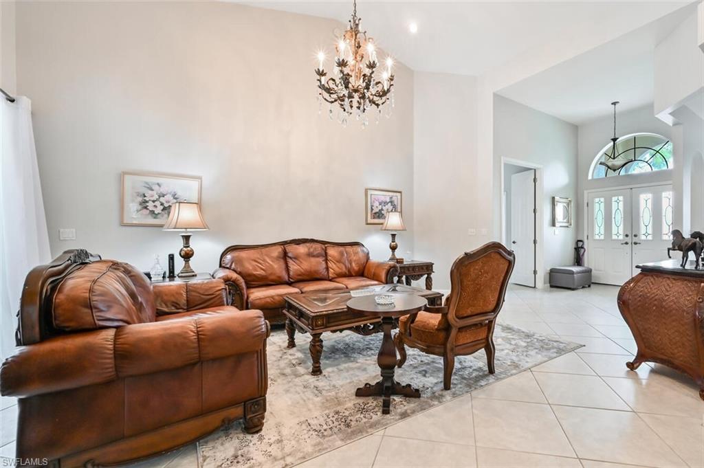 6545 Chestnut Circle Naples, FL 34109 - Photo 6 of 43 a living room with furniture and a chandelier