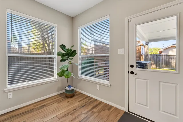 a view of an empty room and a window
