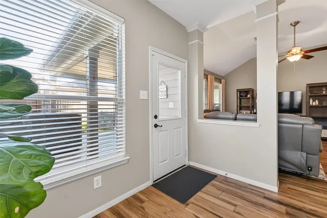 a view of a bedroom with a window and wooden floor