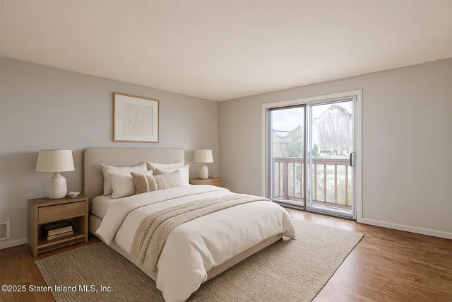 a bedroom with a bed and a night stand