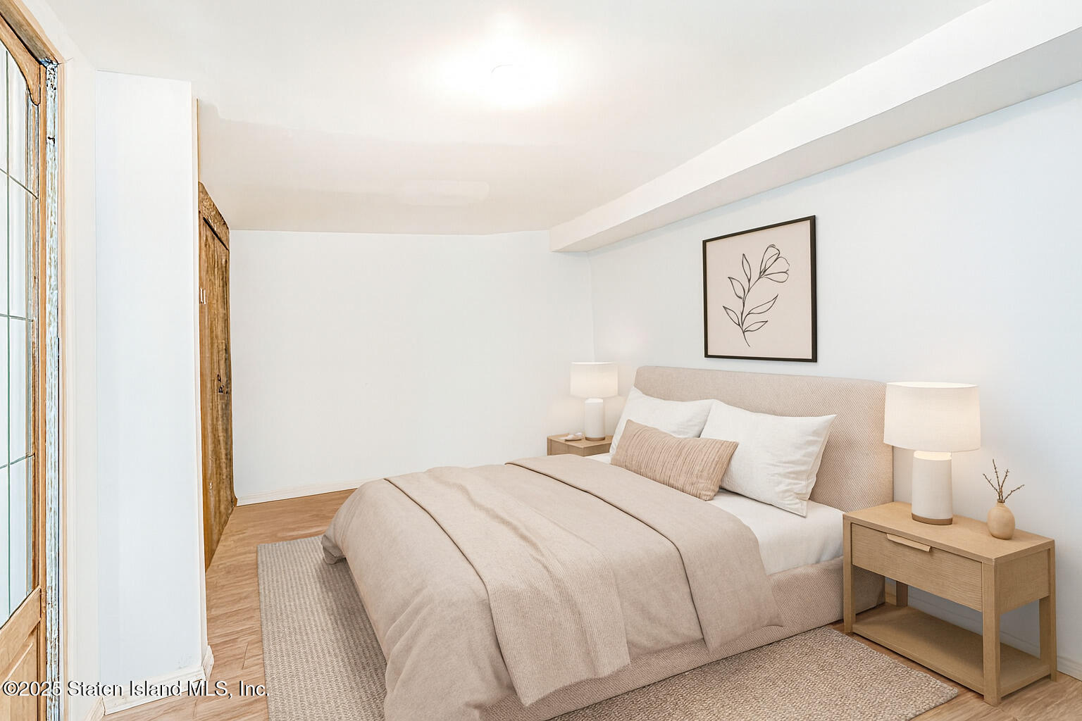 318 Travis Avenue Staten Island, NY 10314 - Photo 18 of 24 a bedroom with a bed and a painting on the wall