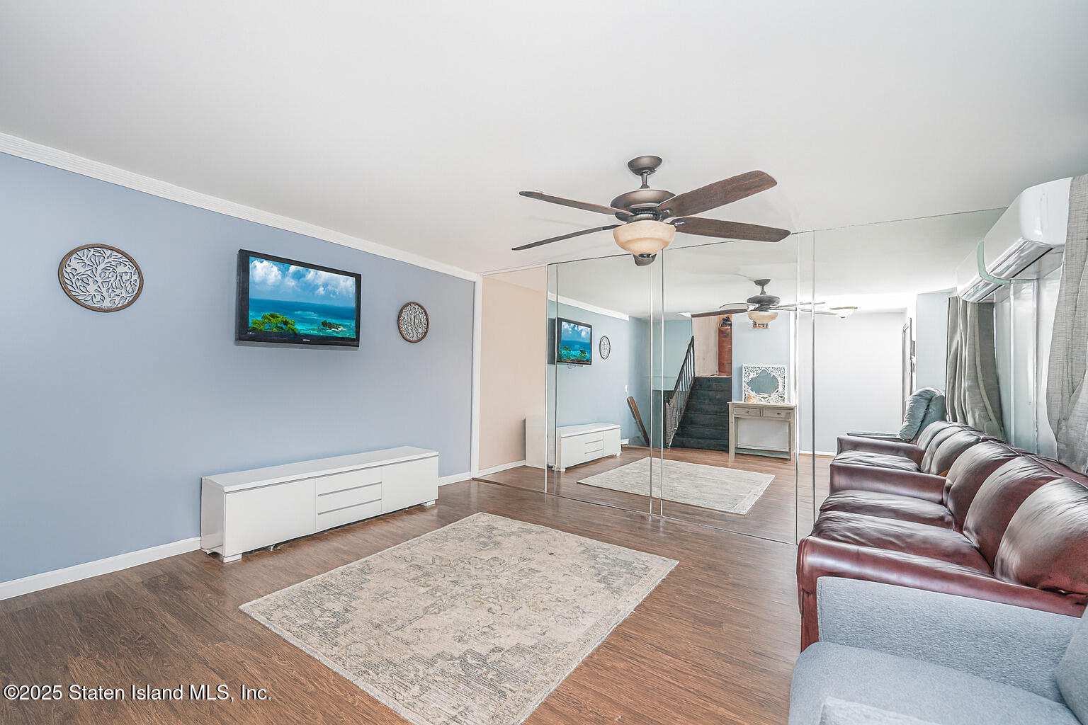 318 Travis Avenue Staten Island, NY 10314 - Photo 4 of 24 a living room with furniture and wooden floor