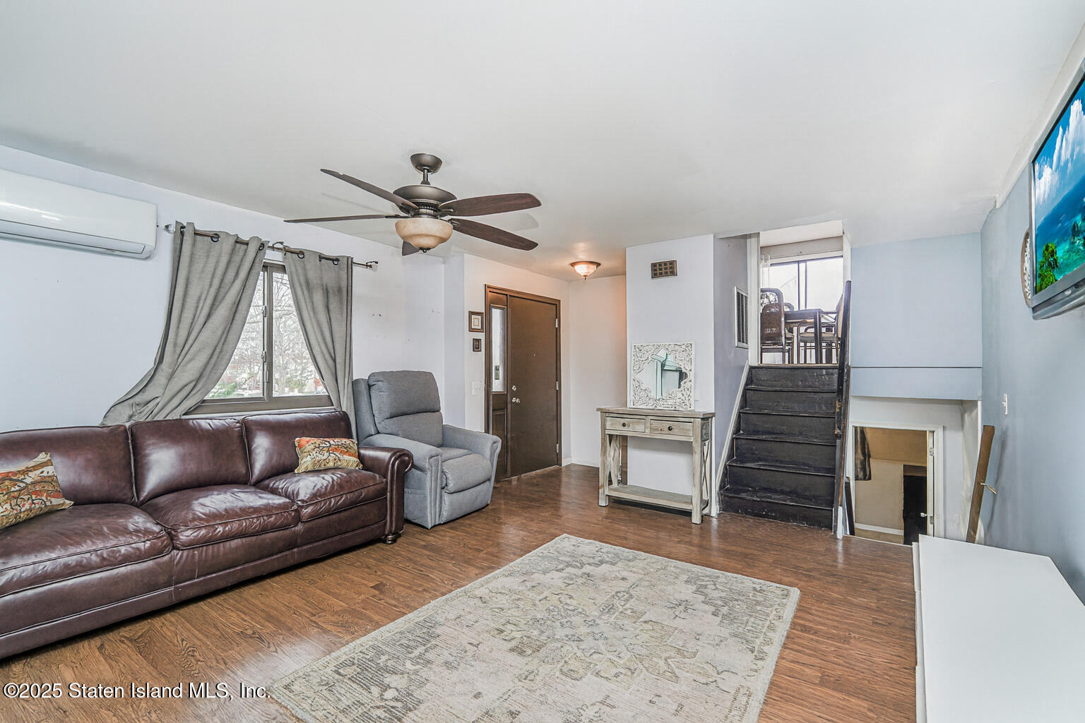 318 Travis Avenue Staten Island, NY 10314 - Photo 5 of 24 a living room with furniture and a wooden floor