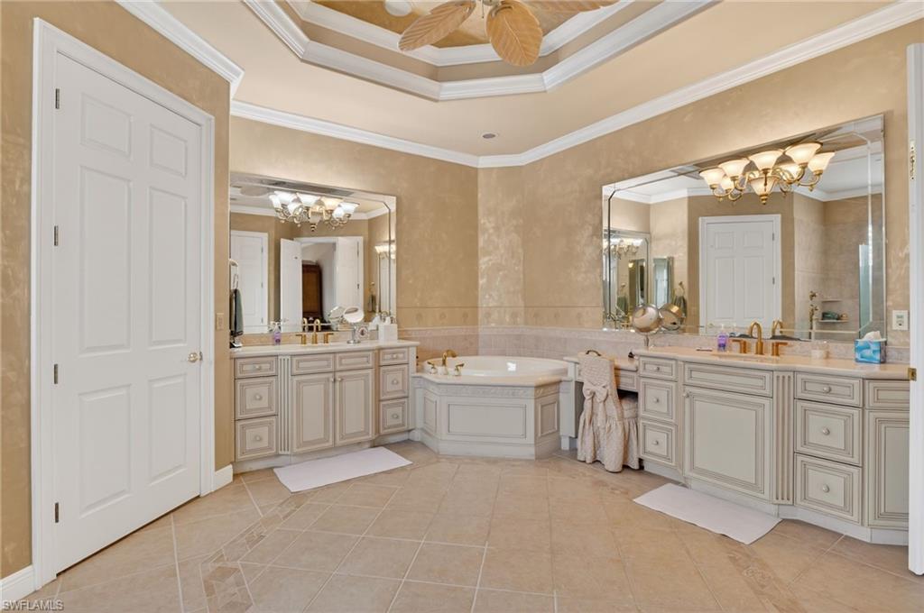1964 Rialto Way Alva, FL 33920 - Photo 22 of 50 a large bathroom with a large mirror vanity and a sink
