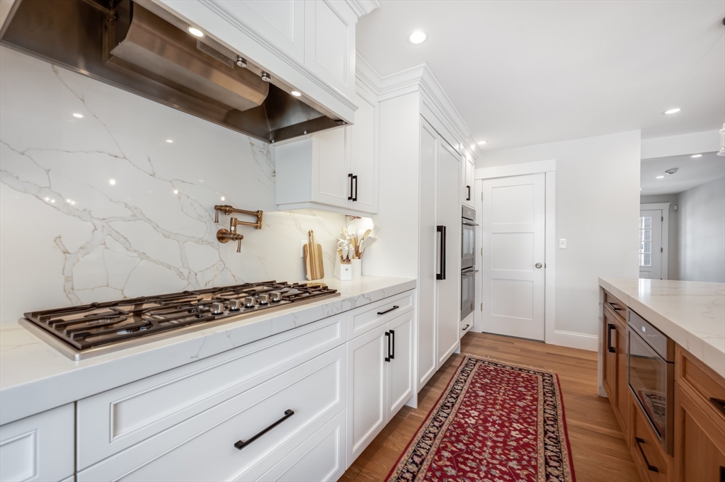 6 Stanwood Point, Unit A Gloucester, MA 01930 - Photo 4 of 25 a kitchen with stainless steel appliances a refrigerator a sink and white cabinets