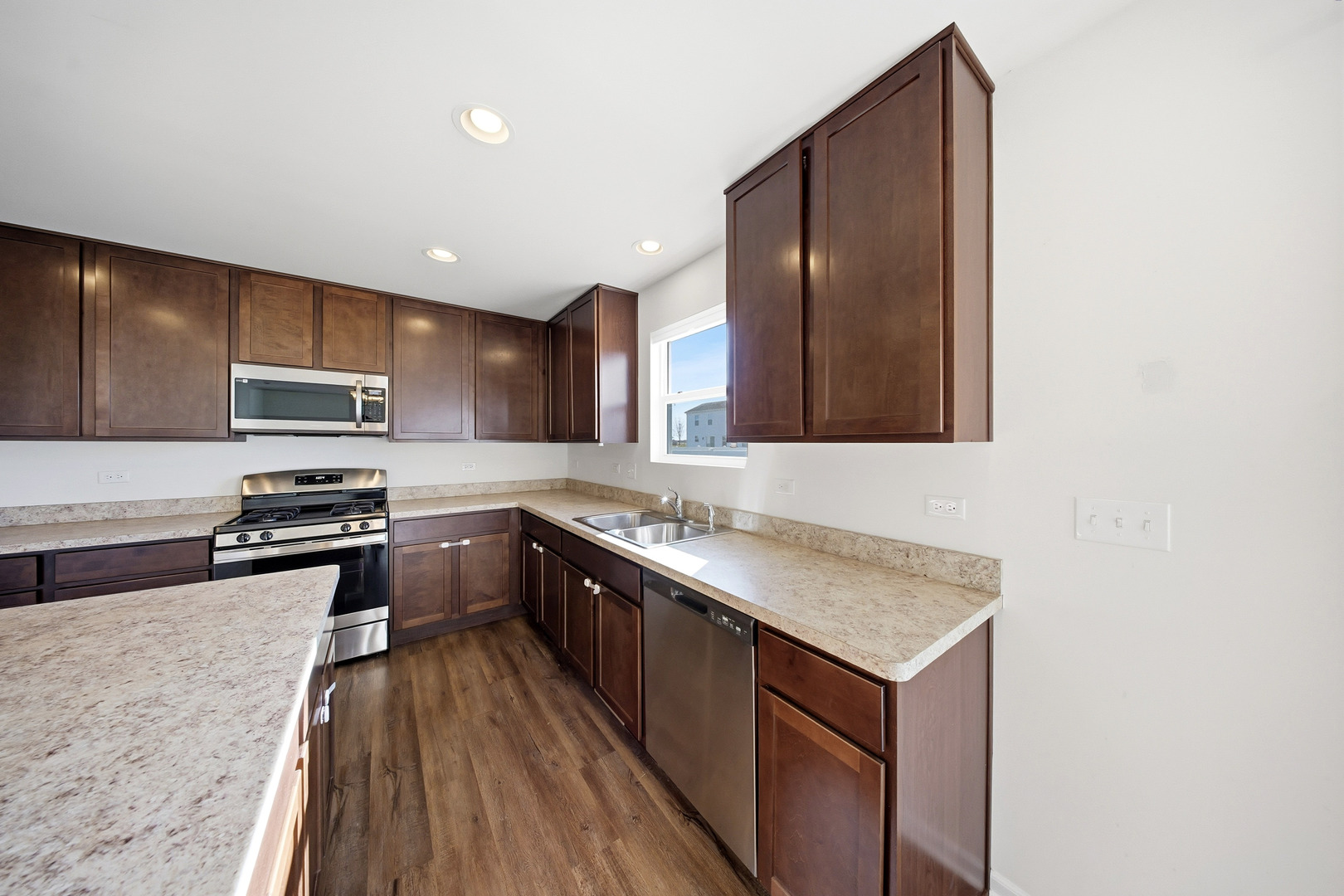 949 Hyte Street Plano, IL 60545 - Photo 13 of 51 a kitchen with stainless steel appliances granite countertop wooden cabinets a stove top oven a sink and dishwasher
