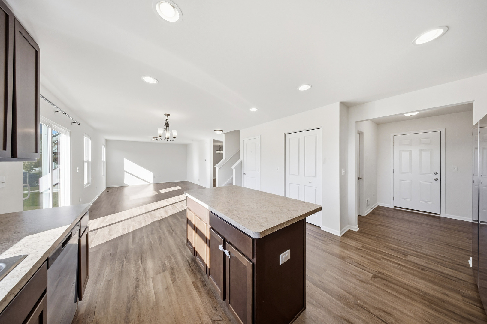 949 Hyte Street Plano, IL 60545 - Photo 15 of 51 a open kitchen with stainless steel appliances granite countertop a lot of cabinets and wooden floor