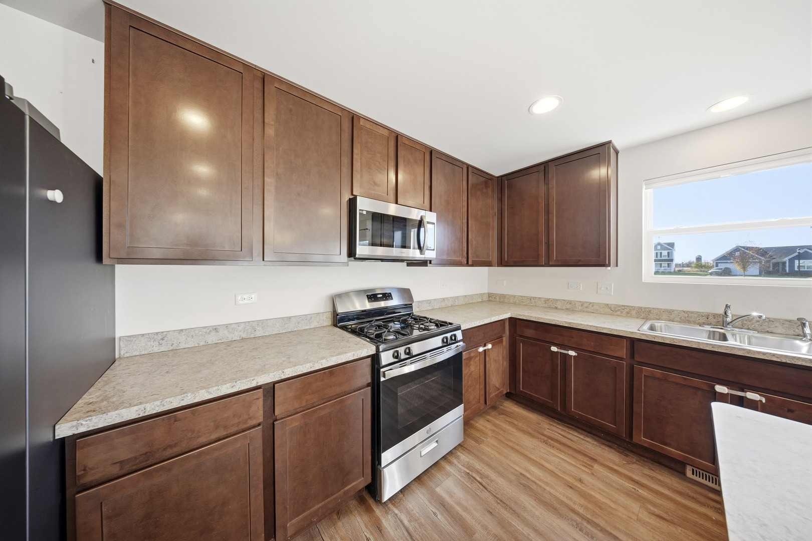 949 Hyte Street Plano, IL 60545 - Photo 16 of 51 a kitchen with sink a microwave and cabinets