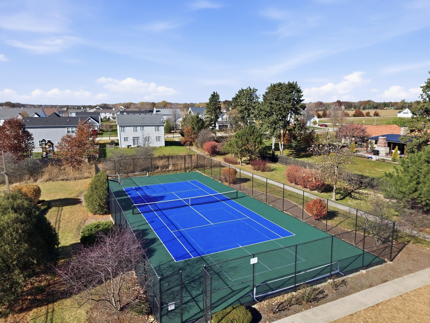 949 Hyte Street Plano, IL 60545 - Photo 48 of 51 a view of a tennis ground with sitting area