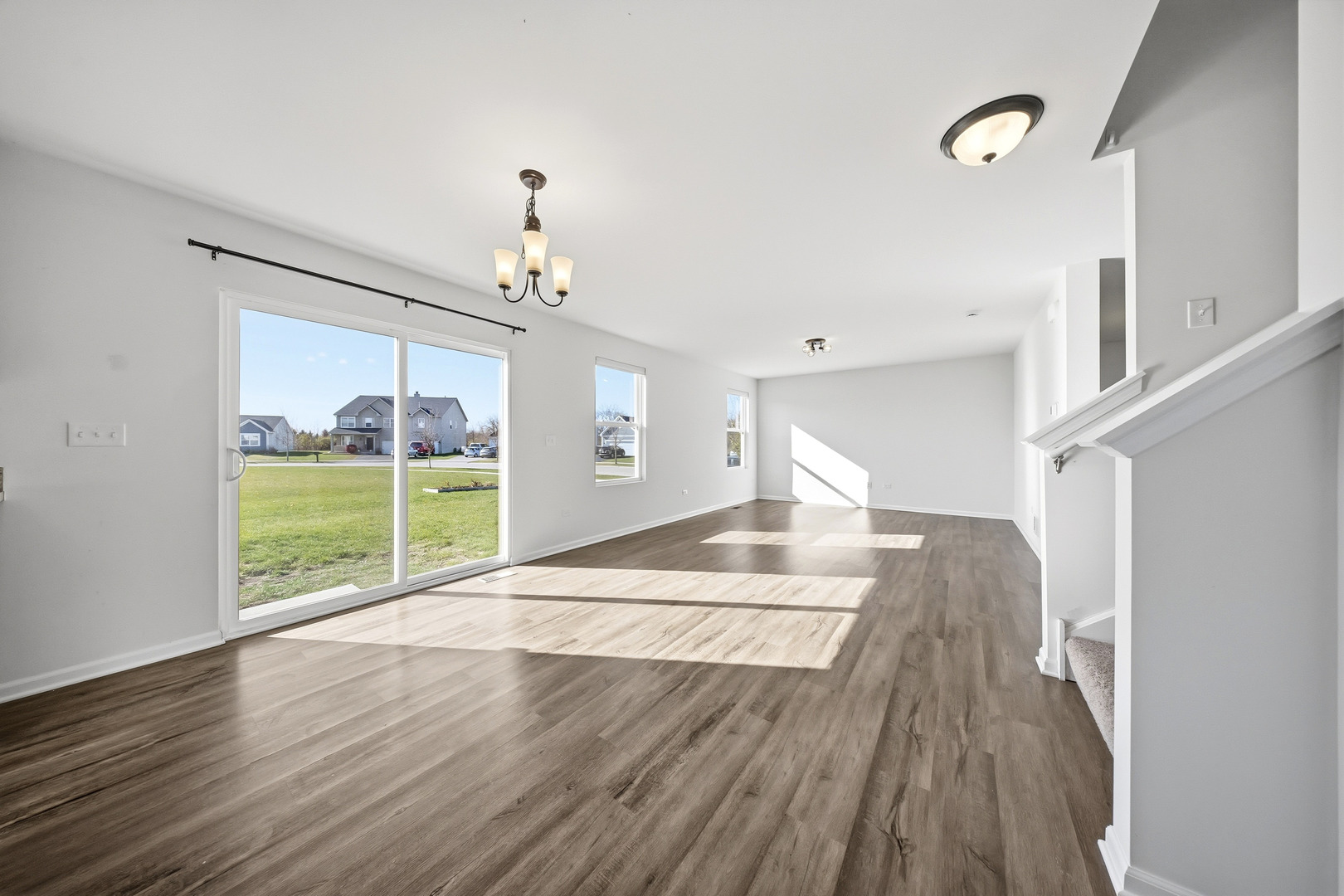 949 Hyte Street Plano, IL 60545 - Photo 8 of 51 a view of a room with wooden floor fan and windows