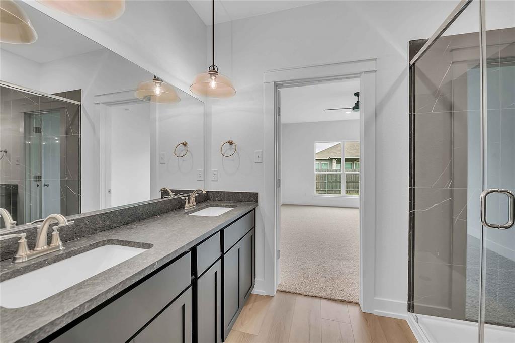 2812 Teasdale Road Lorena, TX 76655 - Photo 6 of 15 a bathroom with a granite countertop sink a mirror and a shower