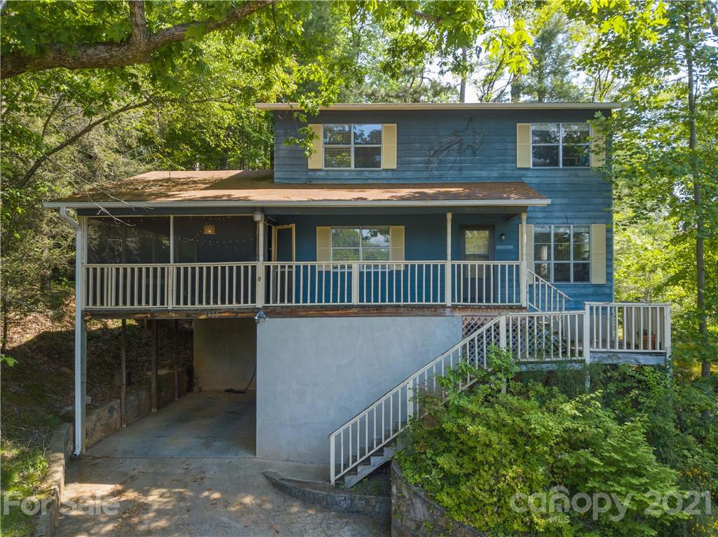 1035 County Road Waynesville, NC 28785 - Photo 1 of 15 a view of a house with a small yard and wooden fence