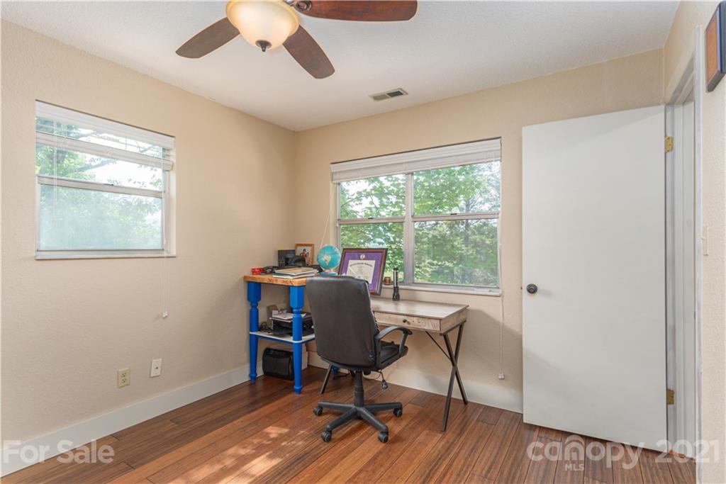 1035 County Road Waynesville, NC 28785 - Photo 11 of 15 a workspace with wooden floor and a window
