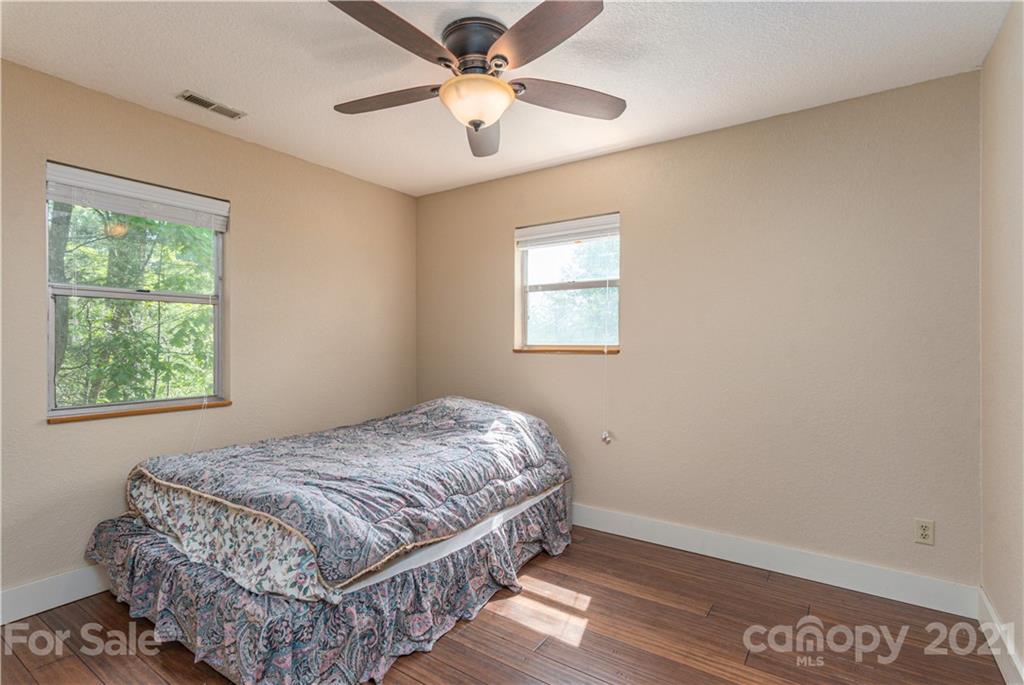 1035 County Road Waynesville, NC 28785 - Photo 13 of 15 a bedroom with a bed and a window