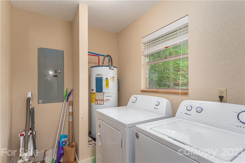 1035 County Road Waynesville, NC 28785 - Photo 5 of 15 a view of washer and dryer with bathroom in the background