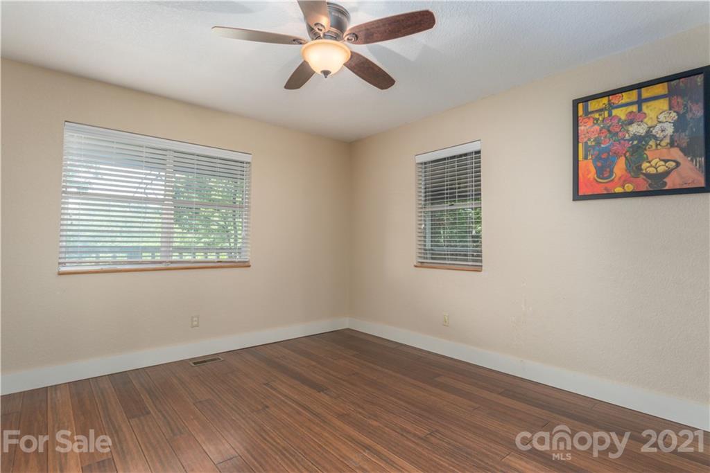 1035 County Road Waynesville, NC 28785 - Photo 7 of 15 a view of an empty room with wooden floor and a window