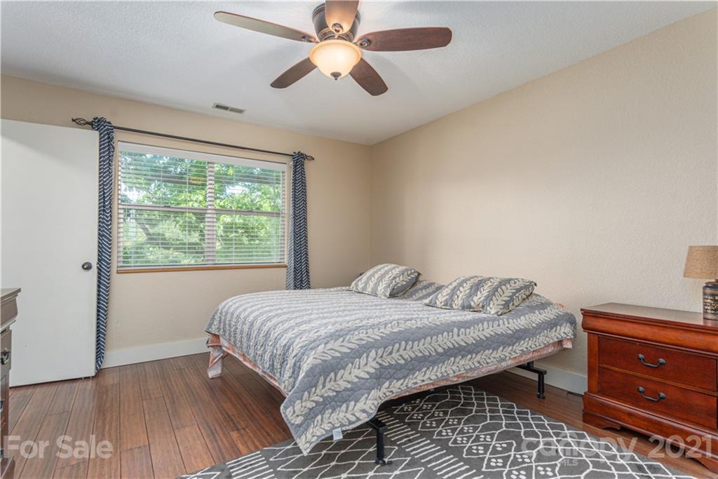1035 County Road Waynesville, NC 28785 - Photo 9 of 15 a bedroom with a bed and a dresser