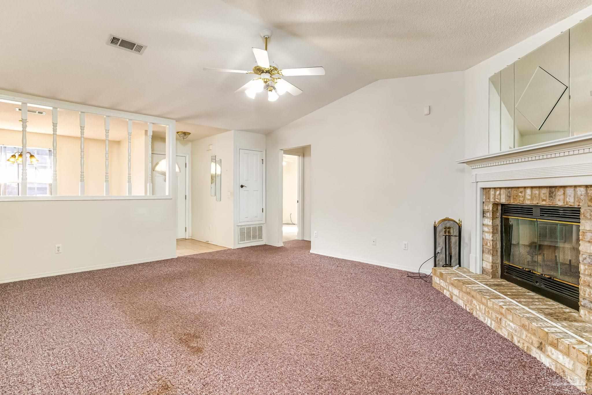 5503 Chantilly Circle Milton, FL 32583 - Photo 5 of 21 a view of an empty room with chandelier and fireplace
