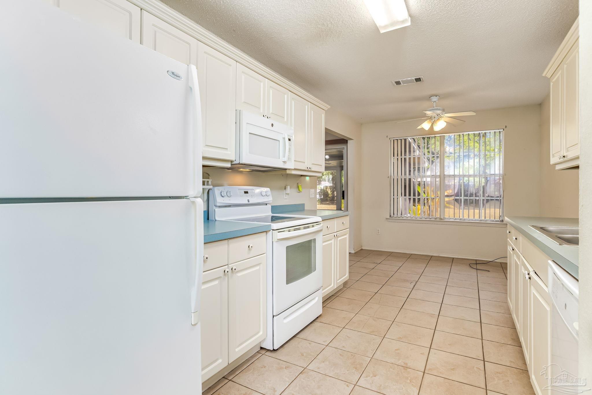 5503 Chantilly Circle Milton, FL 32583 - Photo 8 of 21 a kitchen with a white cabinets and white appliances