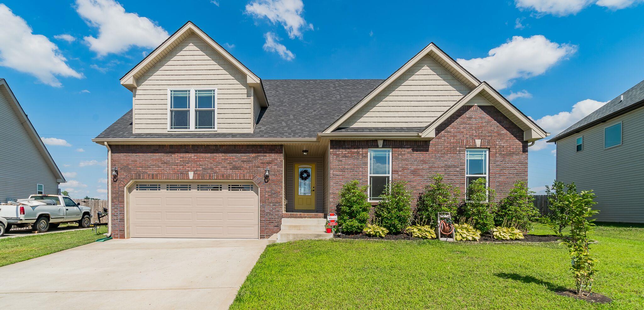 1753 Springhaven Drive Clarksville, TN 37042 - Photo 1 of 18 a front view of a house with a yard and garage