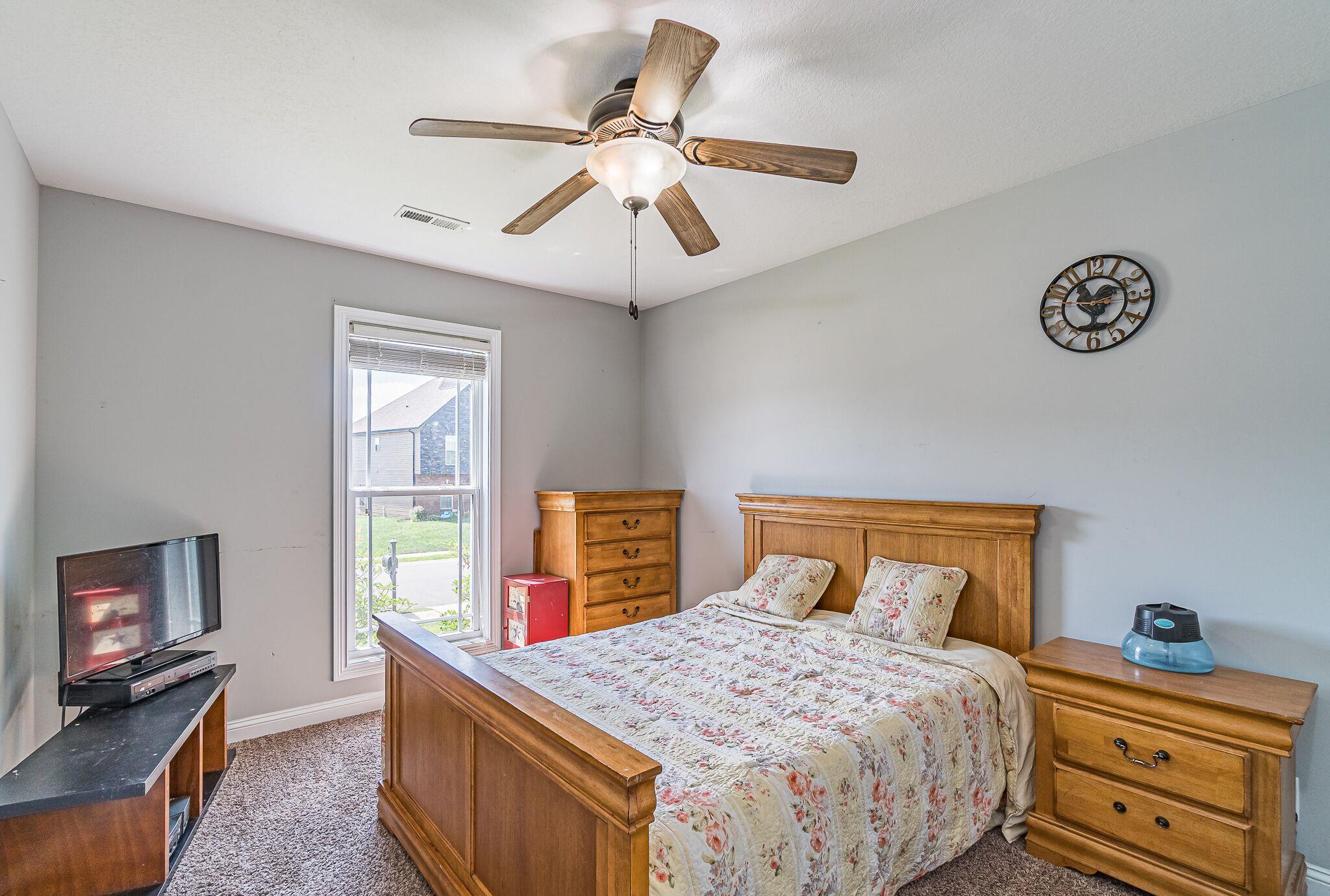 1753 Springhaven Drive Clarksville, TN 37042 - Photo 12 of 18 a bedroom with a bed and a chandelier