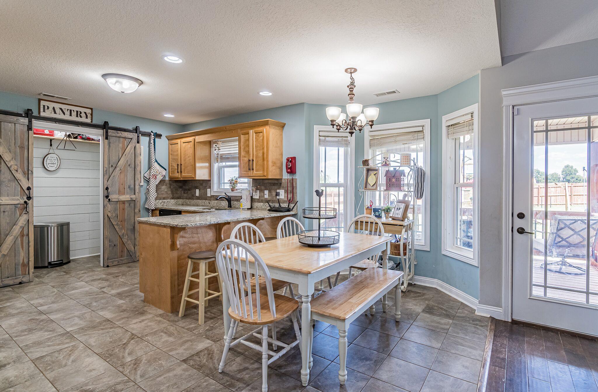 1753 Springhaven Drive Clarksville, TN 37042 - Photo 6 of 18 a dining room with granite countertop furniture and a chandelier