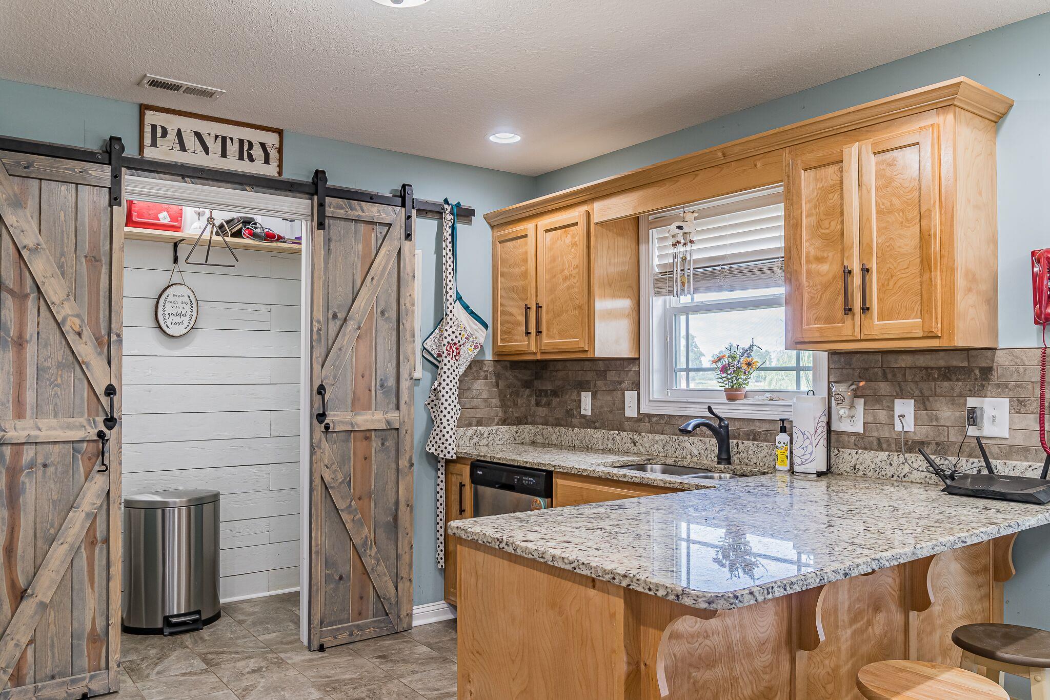 1753 Springhaven Drive Clarksville, TN 37042 - Photo 8 of 18 a kitchen with stainless steel appliances granite countertop a sink stove and refrigerator