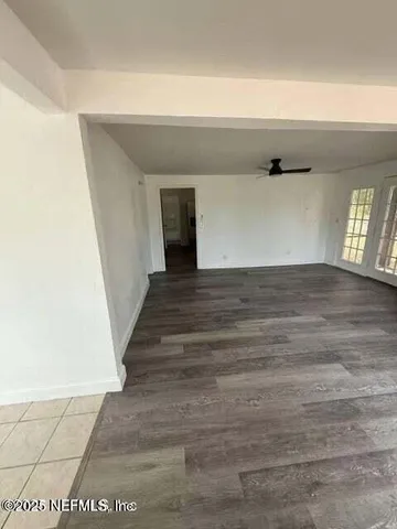 a view of an empty room and wooden floor