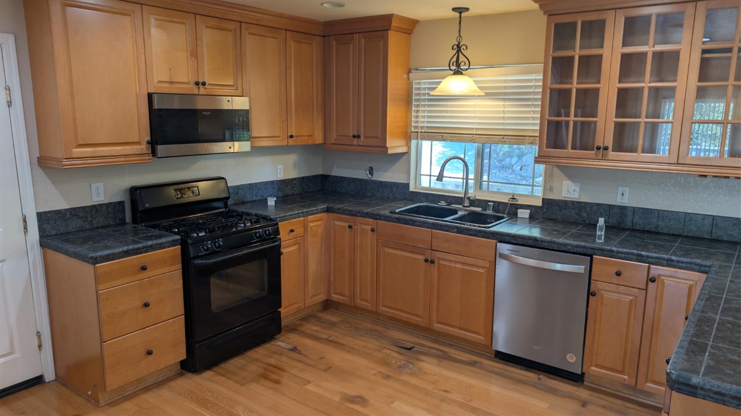 3248 Sudbury Road Cameron Park, CA 95682 - Photo 4 of 41 a kitchen with granite countertop a stove and a microwave