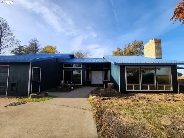 a view of a house with a large window and chair