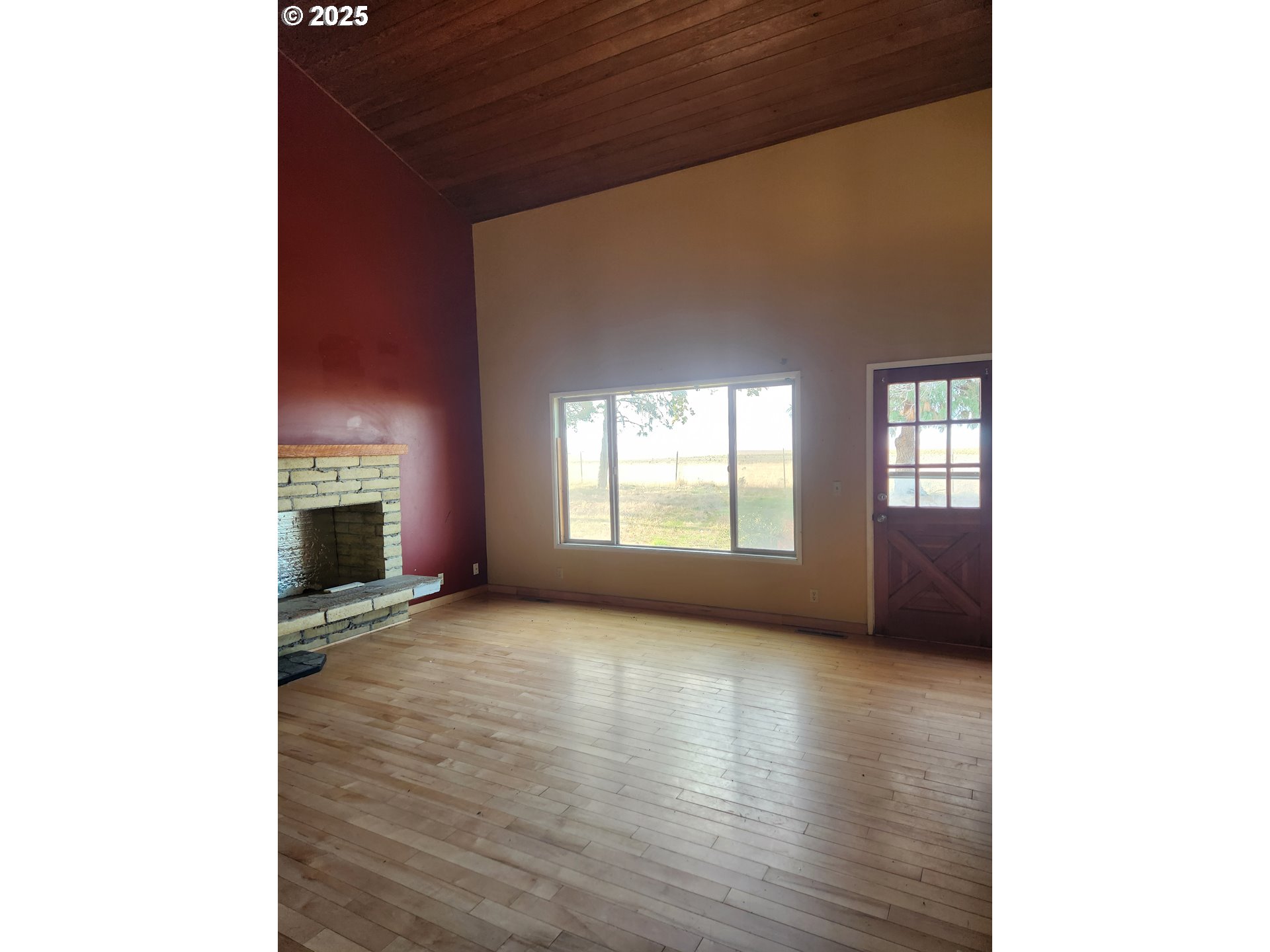 68766 Weatherford Road Arlington, OR 97812 - Photo 24 of 27 a view of a livingroom with wooden floor and a fireplace