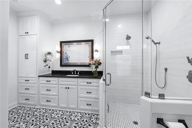 a bathroom with a sink a toilet and shower