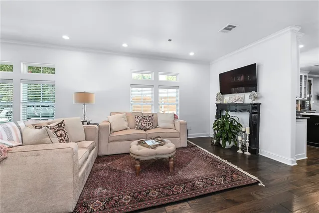 a living room with furniture a flat screen tv and a large window