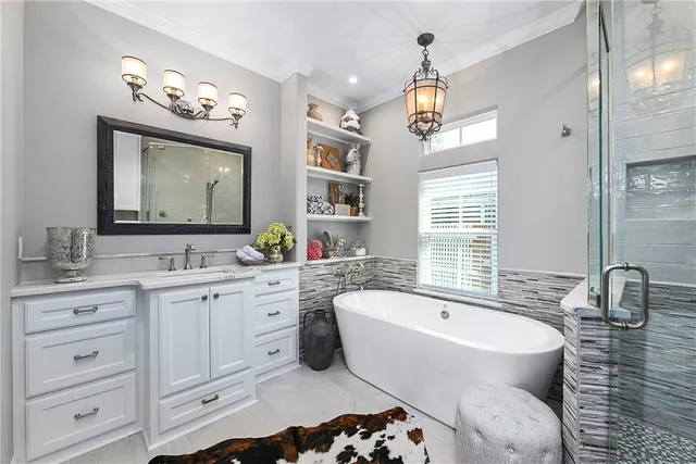 a spacious bathroom with a sink a large mirror and a bathtub