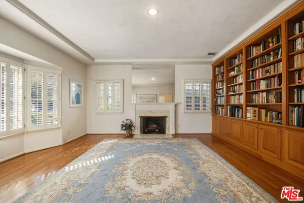 a view of an empty room with window and fire place