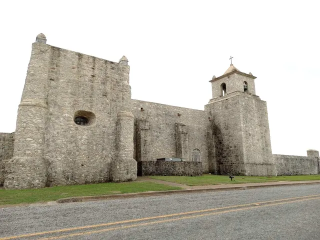 a view of a brick building next to a yard